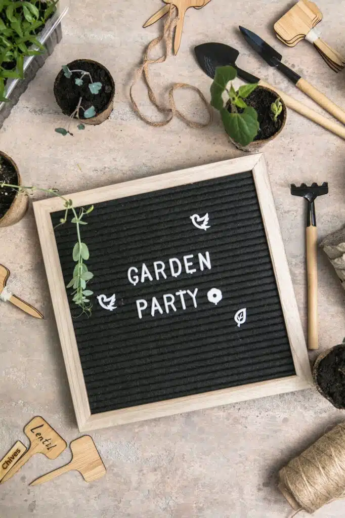 Letter board with text Garden party. Planting seeds in eco-friendly seed pots.