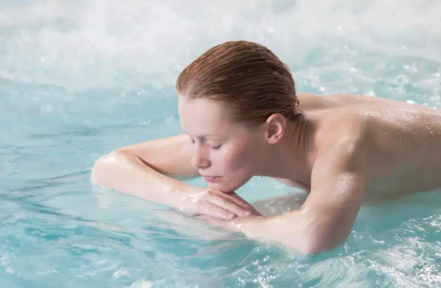 Nude woman relaxing in spa pool